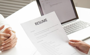 company-representatives-reading-applicant-resume-hiring.jpg